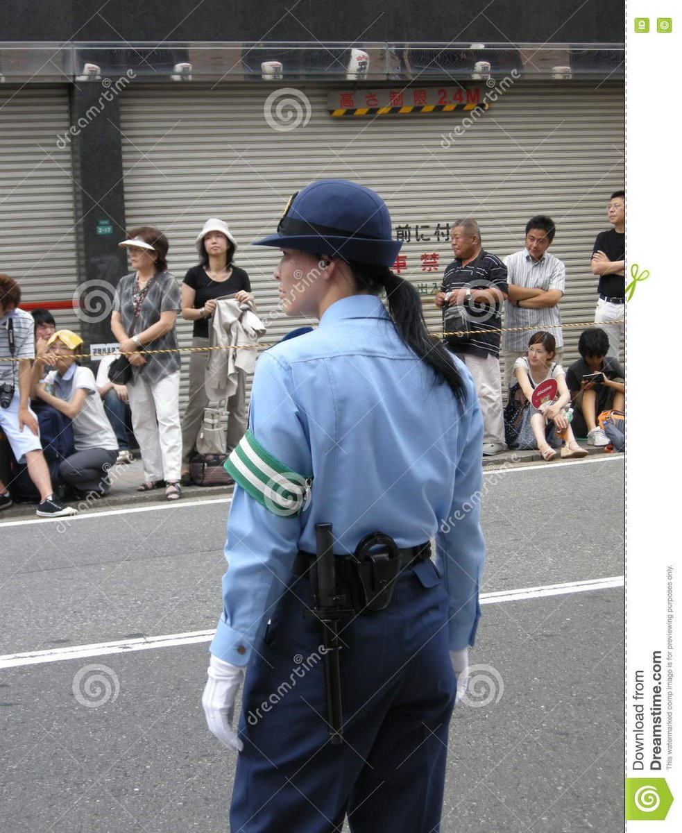Japanese Police Woman directing the crowd lining up in my mentions