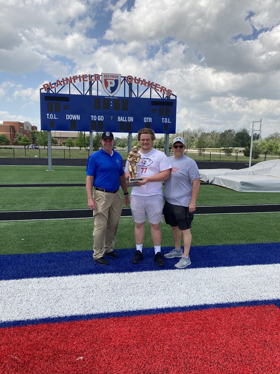 Jaxsen Spears of Plainfield HS receiving his National Football Foundation Scholar Athlete Award from former Colt and Packer great Mike Prior along with dad Jason Spears