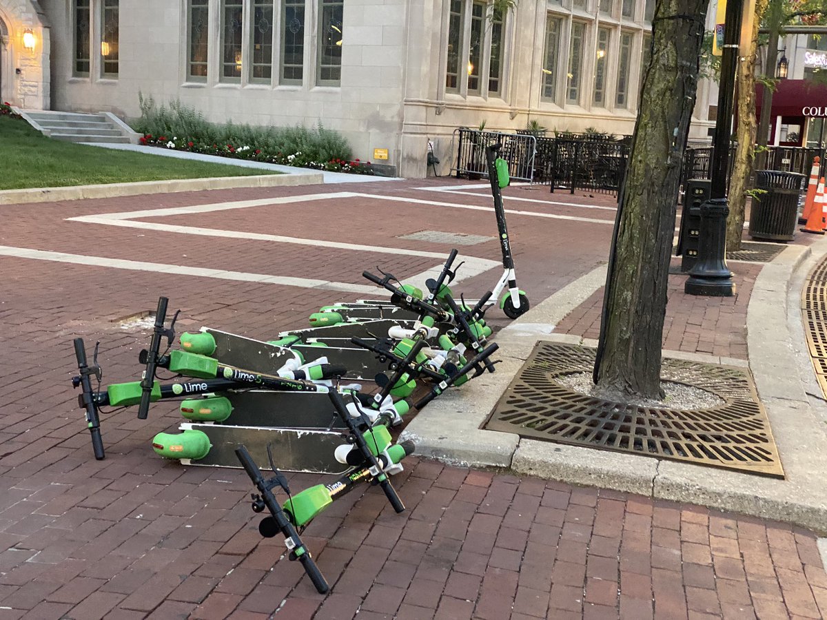 SkyeGraceAitken's tweet photo. On Wednesday, the Lime scooters appeared back on every corner of the circle, lined up, despite the company not allowing those in the protest area to use them last week. These were only some of the scooters. #indianapolisprotest #indyprotests https://t.co/m8looQnK3O