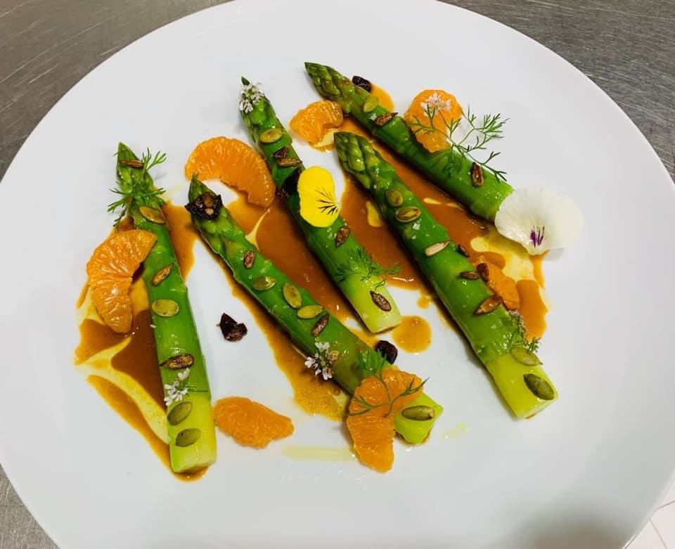 Asparagus with citrus vinaigrette citrus seeds herbs and flowers