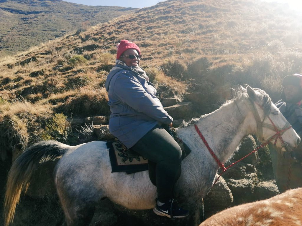 LENASO7's tweet photo. LENASO Executive Director (Ms.Mamello Makoae)on horse back to reach the community in the hard to reach highlands of Lesotho in Bokong. This is what community work means to us, reaching the forgotten villages with HIV and TB interventions. 
@UNFPA_LSO @ekalle_nts @UNAIDSLesotho https://t.co/IOvRznj7U4