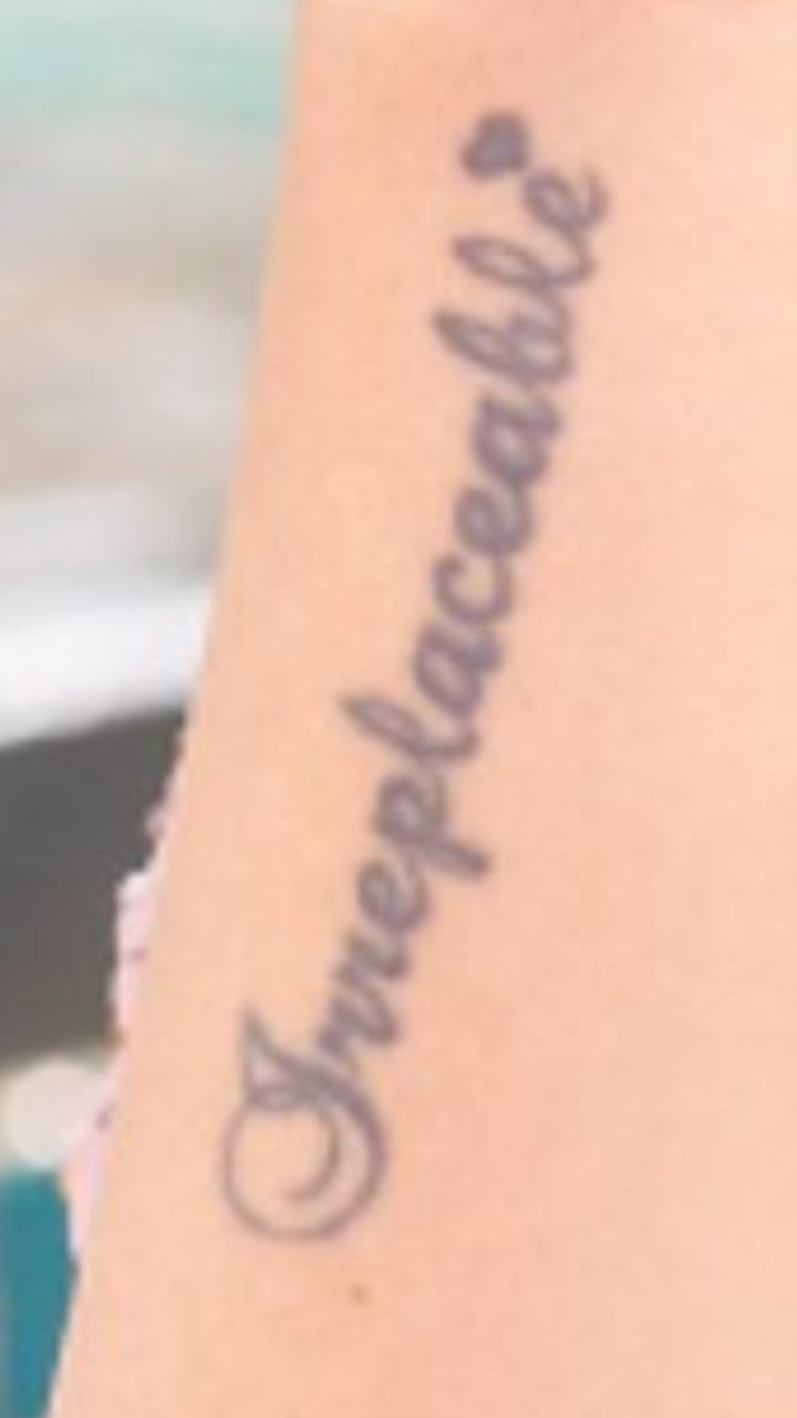Irreplaceable lettering tattoo handwritten on the