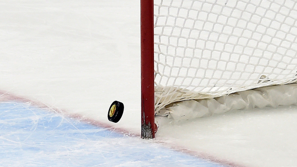 Hockey puck hitting goal post