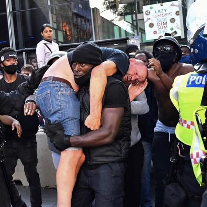 Let this image be seen around the world as BLM protester carries far right counter protester to safety yesterday in London 🙏🏿💯🖤👊🏿