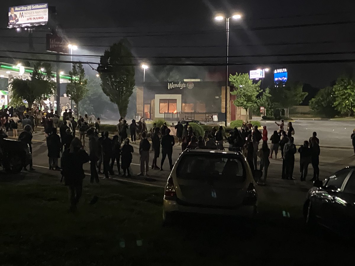 SarahKallis's tweet photo. Protesters have lit a fire inside Wendy’s. @ajc https://t.co/7E6S0vJbkx