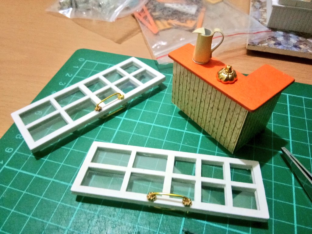 tiny doors with tiny handlestiny countertiny watering cantiny.... idk what it is i'm just following the instructions