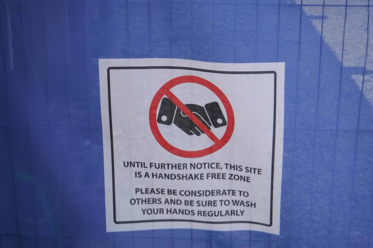 NWHistGraffiti's tweet photo. @Viral_Archive rather like this screen on a local construction site in south Manchester. Especially love the no handshakes sign #ViralShadows #ViralArchive https://t.co/zhK7sWU62N