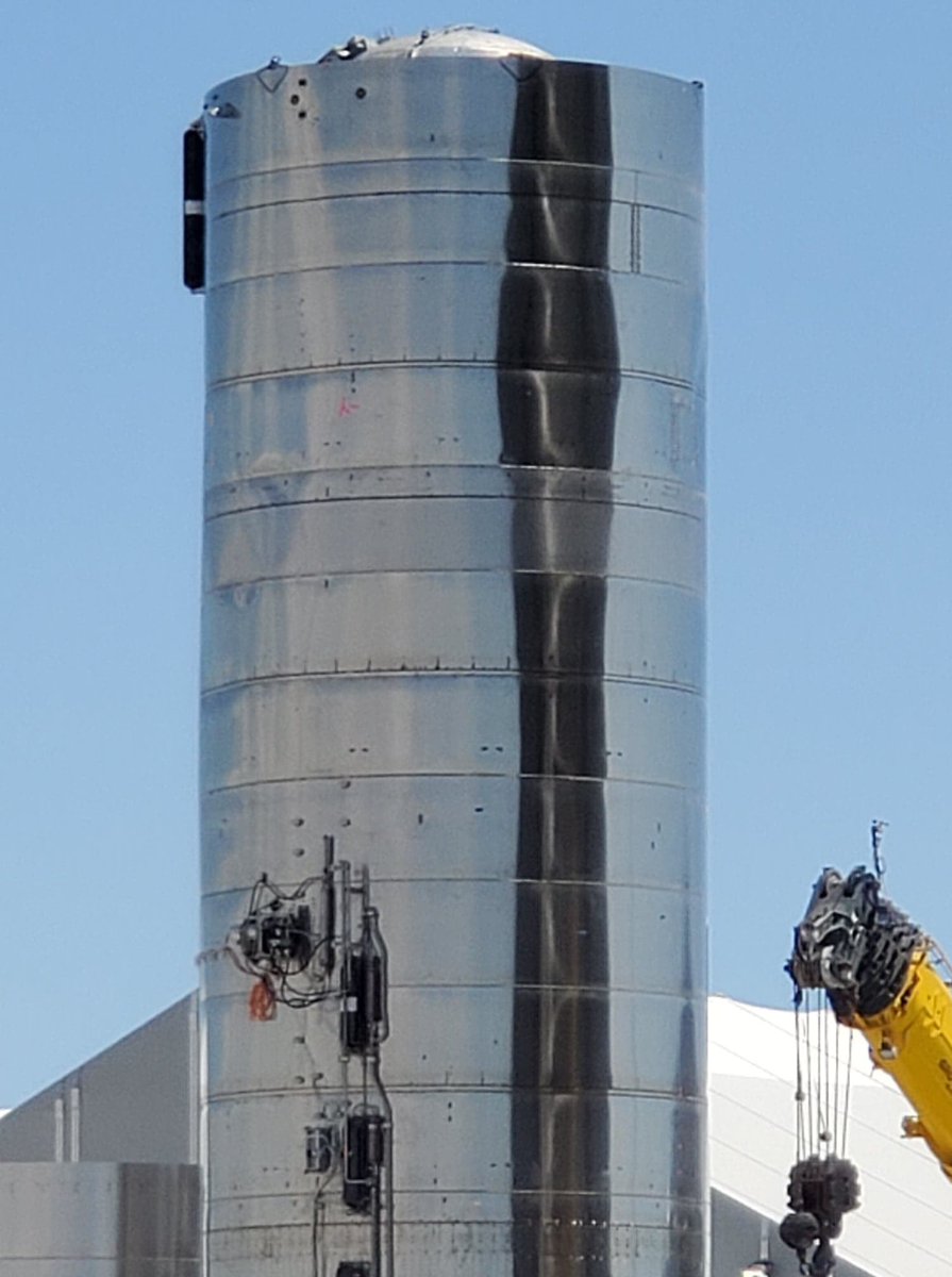 DESpaceX's tweet photo. . @BocachicaMaria1 on scene in #BocaChica #RocketShipyard @Tesla drive unit mounted external SN5. #COPV tanks mounted in debug mode. #Nerdles https://t.co/60p63ZyLkM