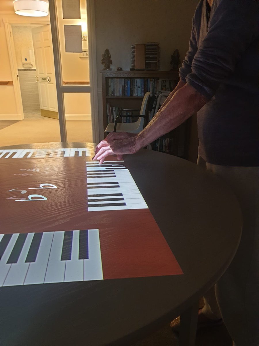 HCH_Wokingham's tweet image. The #Magictable is technology designed to support residents living with dementia. 
The colourful light projections respond to hand and arm movements, enabling residents to play with the light itself, increasing both movement and stimulation.