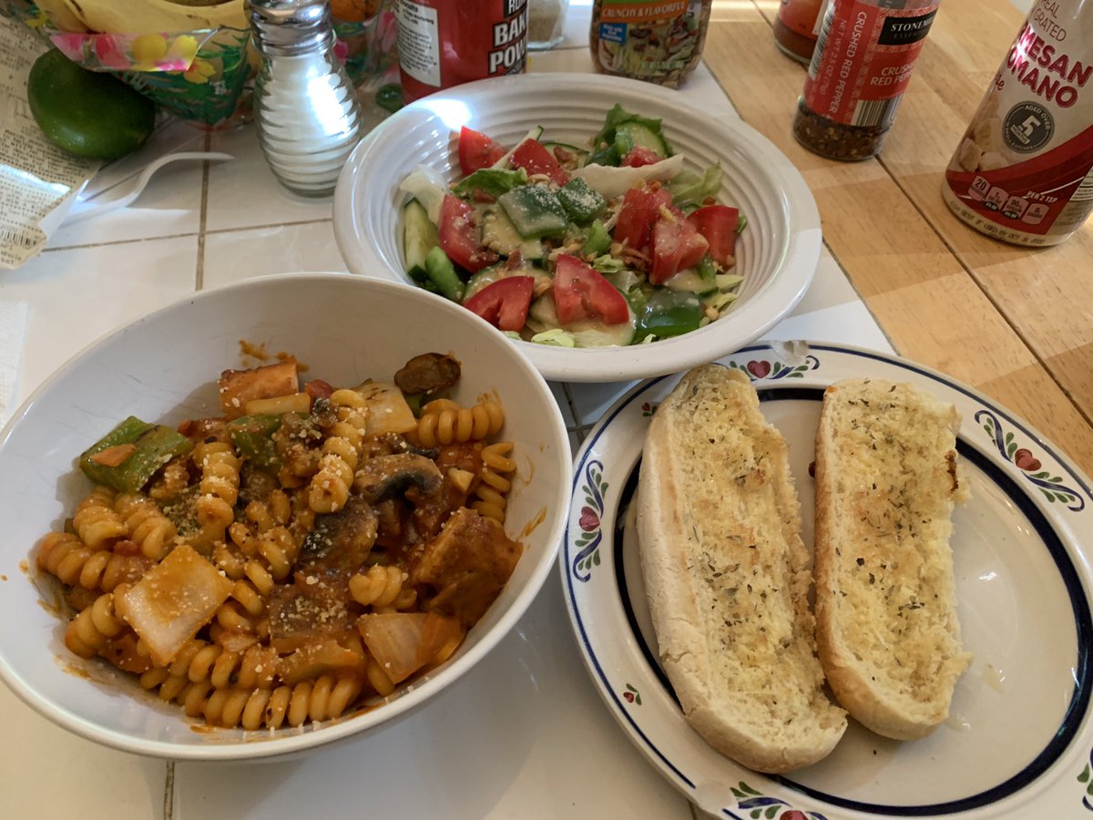 Spicy vodka sauce pasta with garlic bread and a salad