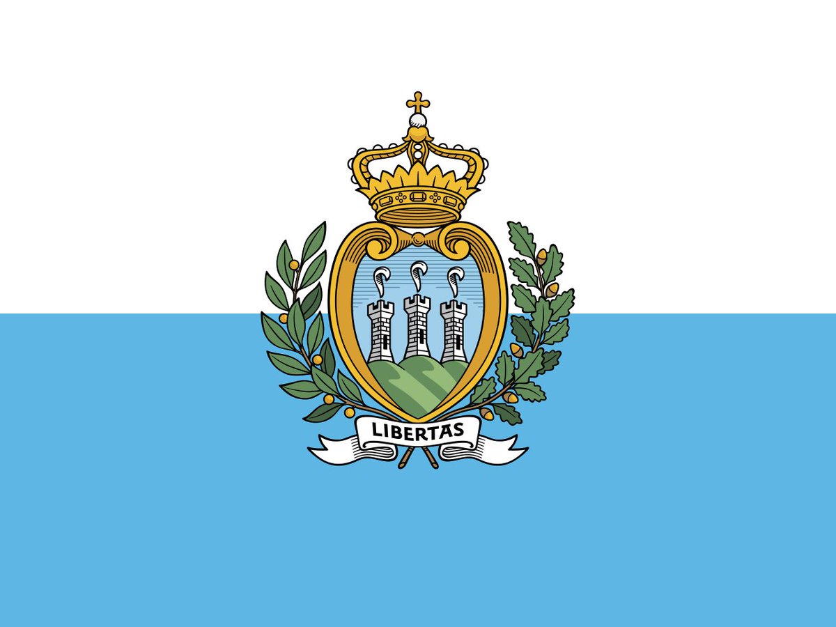 San Marino. 8.5/10. This flag has been in use since 1862. The white stands for peace and the blue for liberty. The emblem features the word LIBERTAS (liberty), as well as depicting the three towers on three peaks of San Marino within a crown, with an oak and laurel wreath.