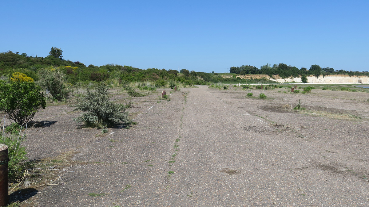 At point 3 we move to the car park. The markings from the bays are still visible as are the bases to the lighting lamp posts. It’s also the point where the only surviving evidence of buildings can be found (point 4 on the mastersheet). This was the car check-in centre.