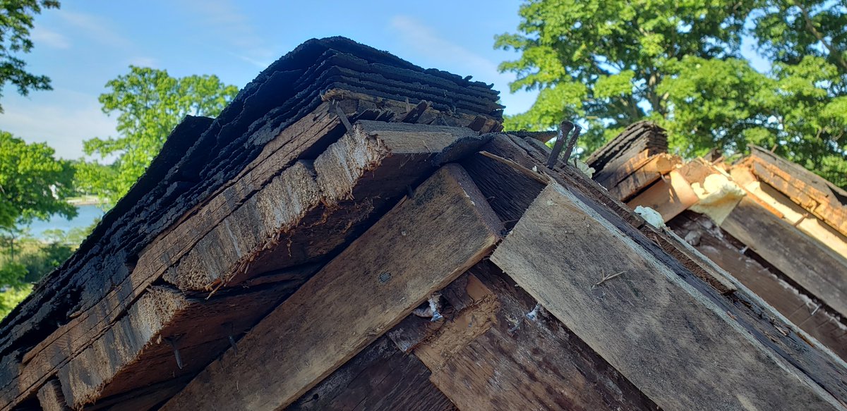 The hand hewned lumber was all cut and assembled without electricity or power tools. And it stayed standing for 300 years.Check out the cross section of the roof we had to remove. I count 8 layers of asphalt shingles, 3 layers of cedar shakes, and 1" planks.