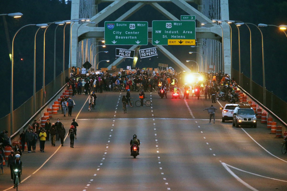 Oregonian's tweet image. "Defund Police" and "No Justice No Peace" banners are hanging from the freeway signs.

(photo by @killendave)