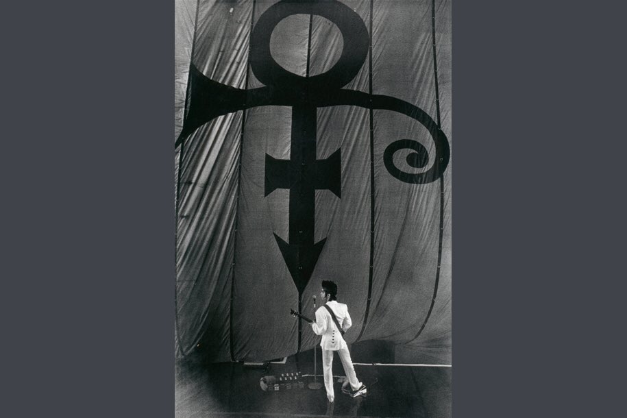 It has been said P wanted the glyph to fuse the astrologically inspired Mars-male and Venus-female symbols creating a new, sexual, gender fluid one. The Symbol evokes a cross harmonisation of ideas often in conflict — Man vs. Woman, Sex vs. Religion.