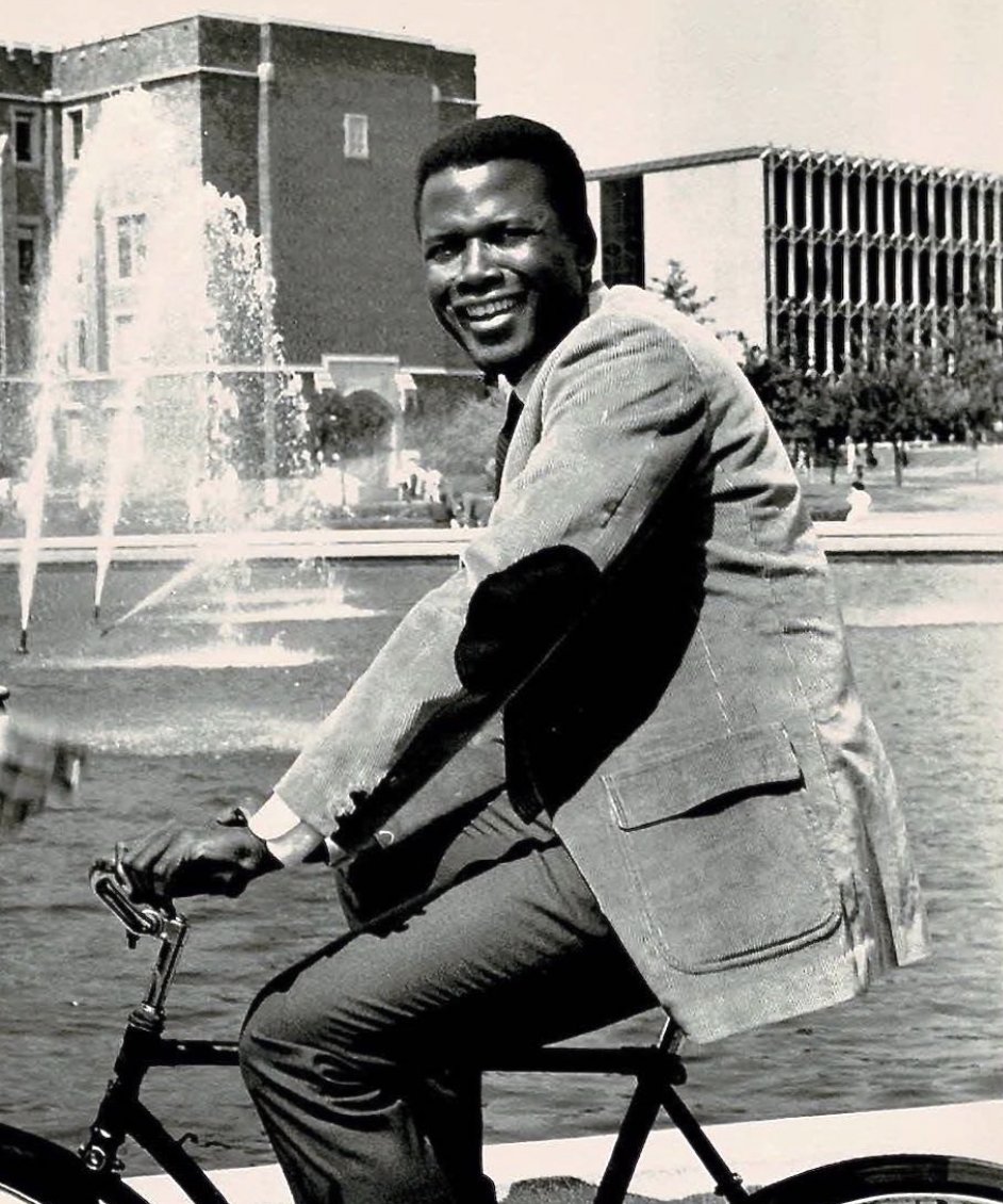 Sidney Poitier on a bike in 1956