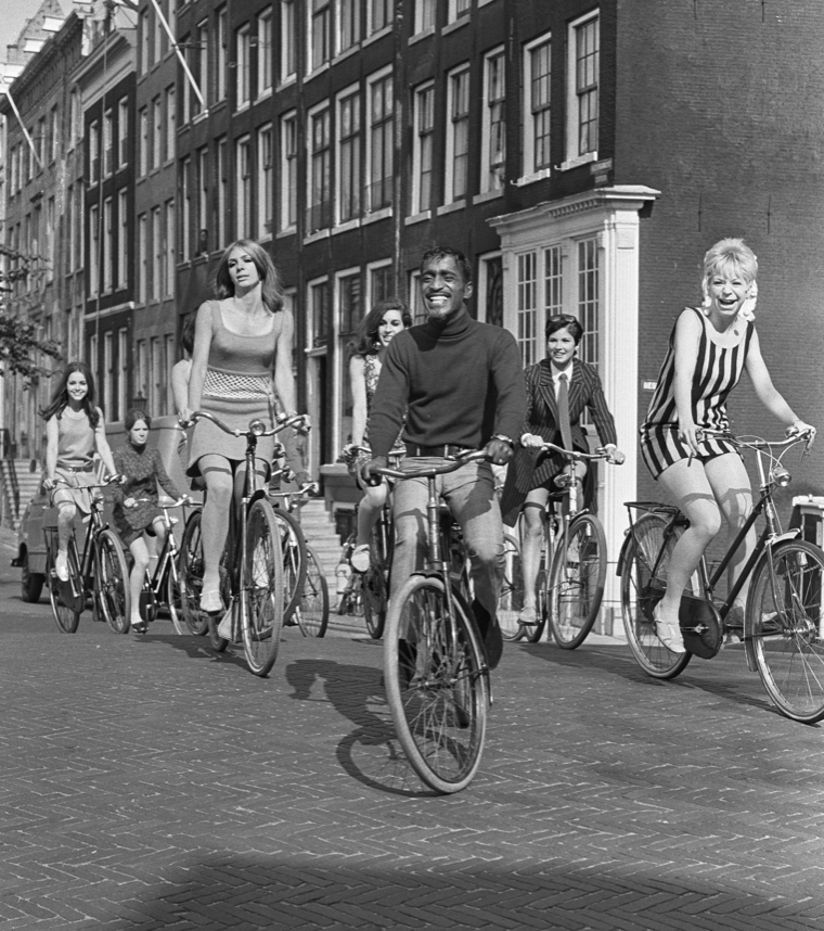 I am going to decline to caption this photo of Sammy Davis, Jr. on a bicycle.