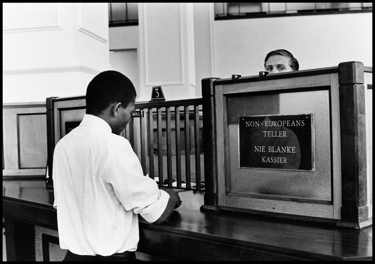 Ernest Cole in Johannesburg. According to Struan Robertson this was in the bank in the building where he and Cole had their studio. There were separate counters for blacks and whites. © Ernest Cole