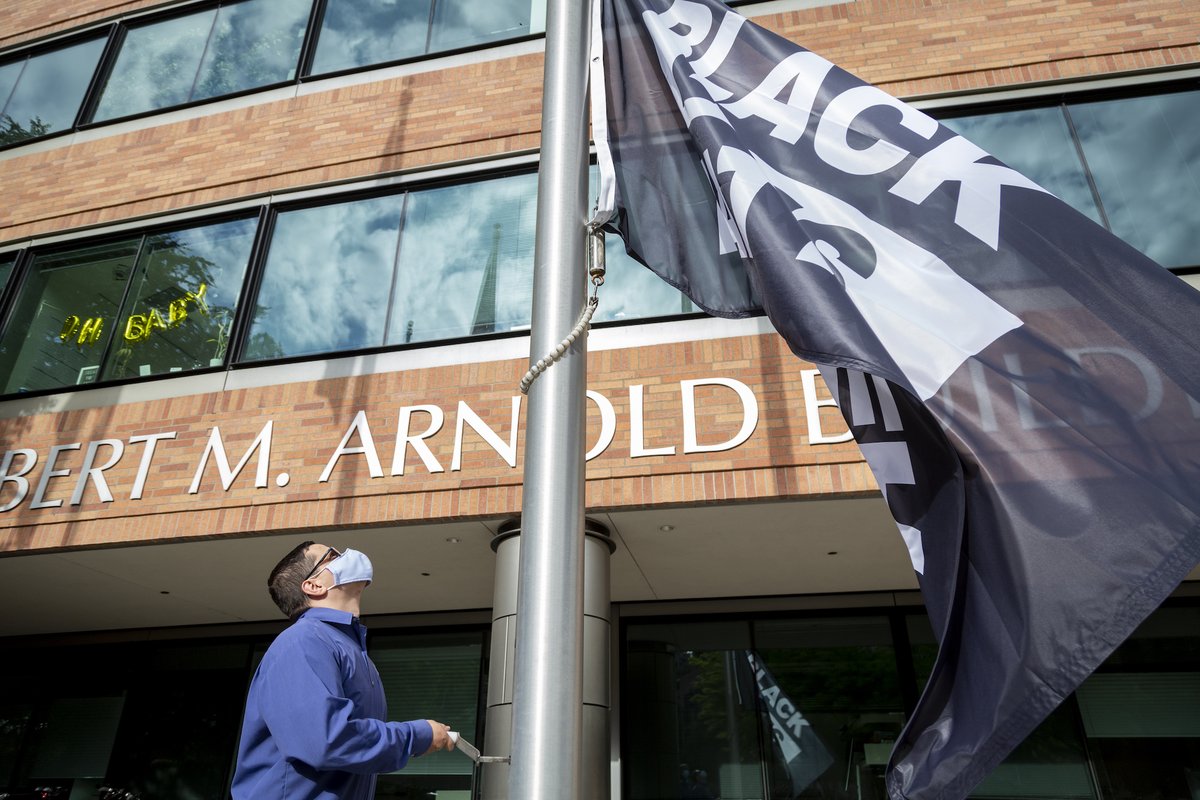 Members of the Fred Hutch staff and faculty raise a new #BlackLivesMatter flag and banner on the Hutch campus in South Lake Union. Learn more about the actions were taking to end racial injustice and promote change at our organization and in our community: bit.ly/3eex42b