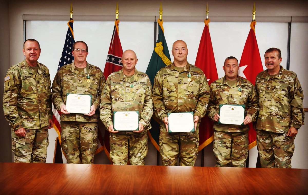 Col. Bobby M. Ginn, Camp Shelby post commander (far right) and Command Sgt. Maj. Gary Graham (far left), presents the #ArmyCommendationMedal to CW2 Charles Dengler, SFC Brad Malone, MSG Lee Parker and 1SG. Jamie Holmes.  (U.S. Army National Guard photo by 2nd Lt. Michael Needham)