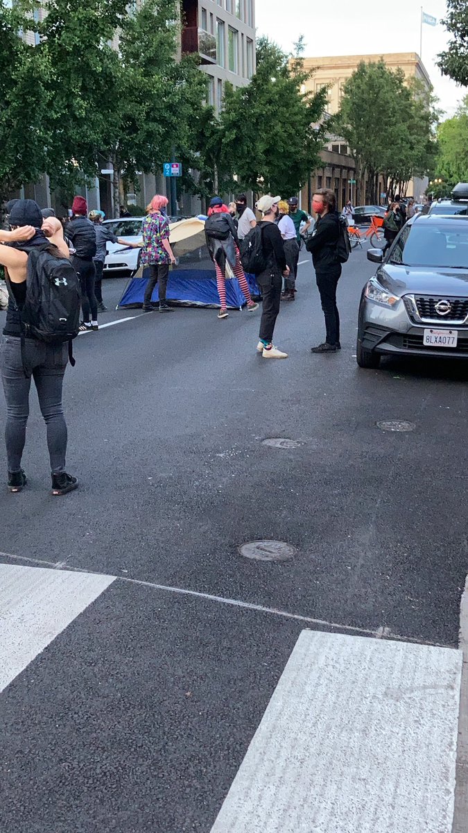 Tents are now being placed in the road on Glisan to block traffic. No cops as of yet but the loudspeaker is, well, loud, so methinks they’re getting some calls.