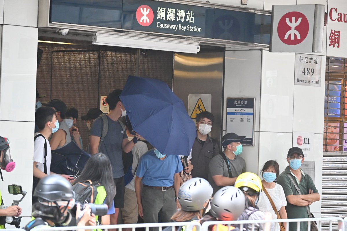 Protestors previously briefly regained access to the intersection, leading to several volleys of pepper balls being fired. Umbrellas were raised in a defensive posture at the entrance of the MTR to shield those behind.
