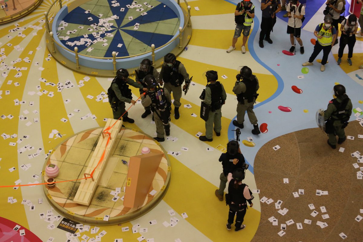 Police have blocked off Times Square to conduct stop and search. Leaflets doxxing officers are scattered around the atrium of the luxury mall in Causeway Bay.