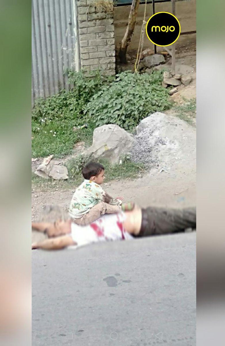 ArifAlvi's tweet photo. Modi's fascist India kills innocent civilians even for raising slogans for liberation of Kashmir. The lament of this 3 yr old boy sitting on the chest of his killed grandfather must be heard by the world &amp; then a soldier stands on body of g/father. Heinous, Criminal, Cruel. 1/2 https://t.co/XecQaUu5Ct