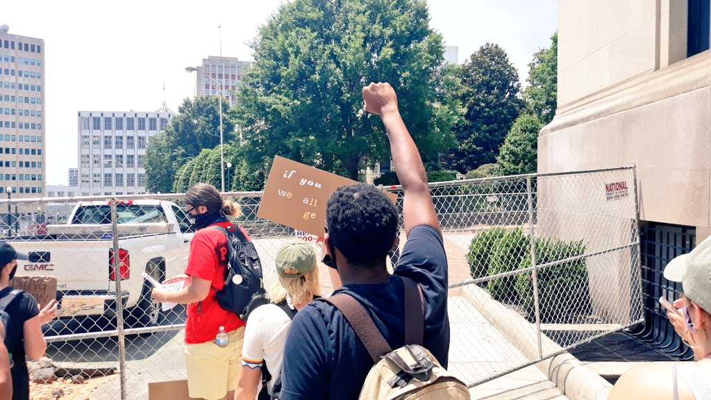 The march stops at a fence on Governor Street. About 100 feet from the Governor's Mansion.