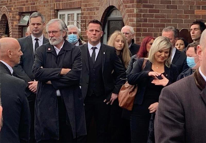 This is the image which has been cropped below by @qnewsdesk of Bobby Storey’s beloved brother Brian extending his hand to <a href="/moneillsf/">Michelle O’Neill</a> outside the family home. Brian has Down’s Syndrome. In my opinion this is despicable journalism and another new low.