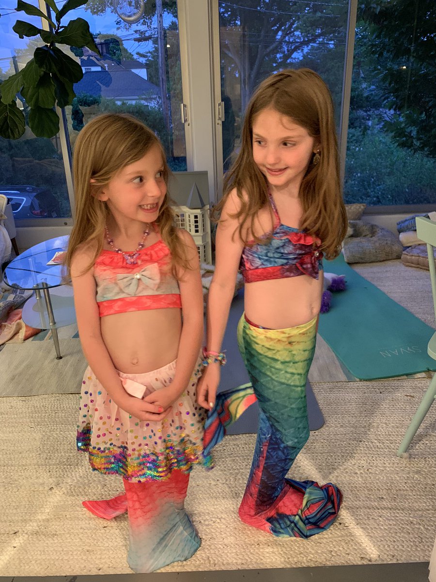 She’s 5. She and her big sister Ruby, who’s 7-1/2, love mermaids. So when we got an inflatable pool for the driveway for our isolated summer, we also ordered mermaid outfits. Aren’t they cute? Two-piece swimsuits with matching tails.