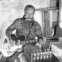 Jesse was an old Black blues folk singeing one-man band. He was born in 1896. As the legend goes this is where Bob first saw a wire rack holding a harmonica around yer neck. A look he gladly copied & made his own.12/