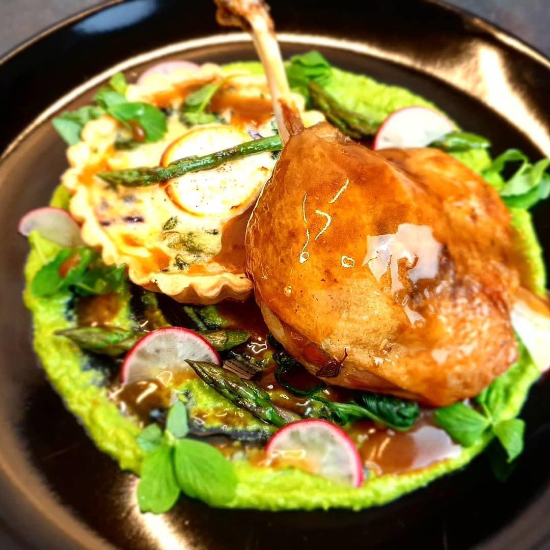 Confit duck leg, goat's cheese, asparagus and red onion tart, sweet peas puree, port reduction sauce