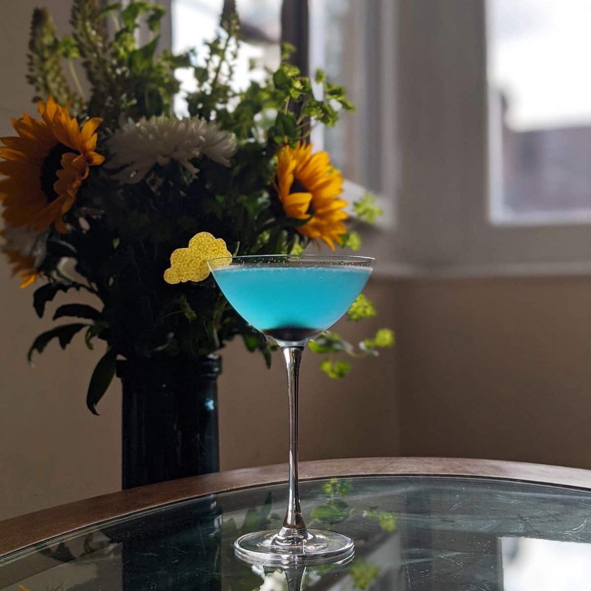 GinMonkeyUK's tweet photo. Today’s #fiveoclockgin has been hilariously chaotic!
The rain gave me an idea (garnish + colour!), so I work out a recipe, test it, balance it, craft the garnish and...the bloody sun comes out.
Shot it anyway. Posted it.
It’s now raining again 😂. Bloody British weather! https://t.co/KmBbf6HMuM