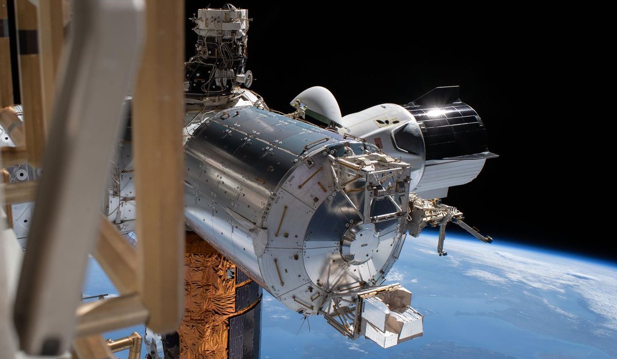 A stunning image of SpaceX's Crew Dragon Endeavour docked with the International Space Station, taken during a spacewalk by NASA astronauts Bob Behnken and Chris Cassidy.