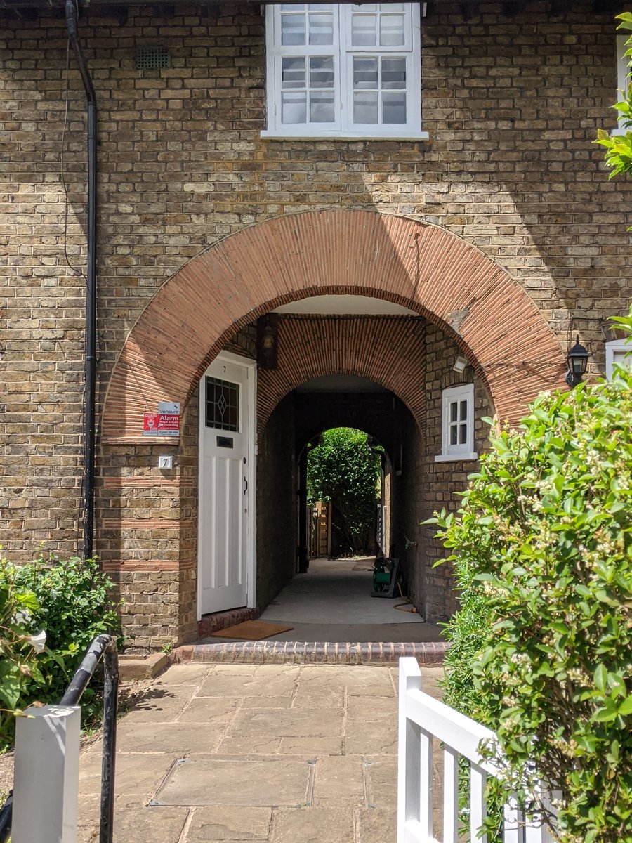6/ Asmuns Place is a cul-de-sac designed by Charles Paget Wade in London Stock brick in Flemish bond with tiling and red brick details. The impressive archways provide tunnel-back access to the rear.