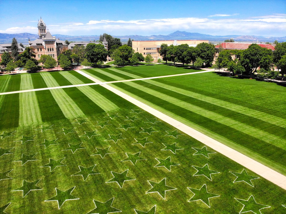 lucerophoto's tweet image. Landscapers at USU mow an American Flag into the grass on the Quad.