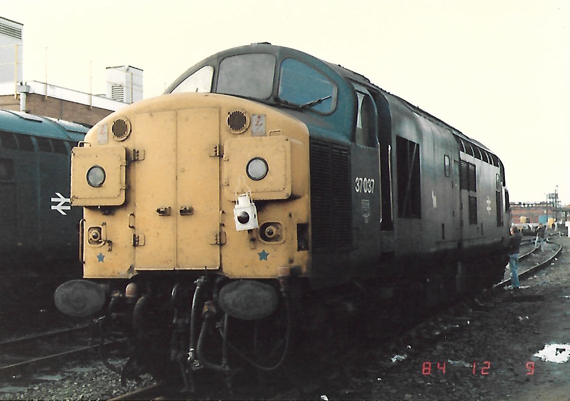 Scottish Split Headcode Box British Rail Class 37 diesel loco 37037 at Crewe Works for overhaul 9/12/84. BR Blue livery, Westie Terrier &amp; a tail lamp! Withdrawn 8/00 &amp; preserved by <a href="/DevonDiesels/">Devon Diesel Society</a> #BritishRail #Crewe #Class37 #trainspotting #ScotRail #diesels #Lamp 🤓