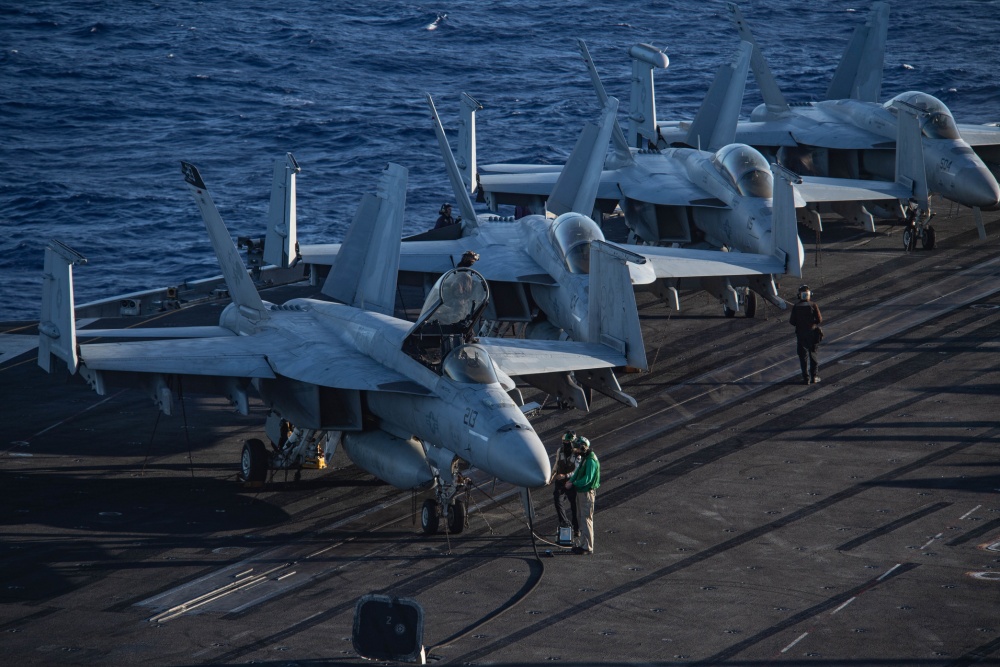 USPACOM's tweet photo. .@USPacificFleet Sailors take diagnostic readings from an F/A-18E #SuperHornet, assigned to the “Tomcatters” of Strike Fighter Squadron #VFA31, on the flight deck of Aircraft Carrier USS Theodore Roosevelt @TheRealCVN71.  #ForgedByTheSea #FreeandOpenIndoPacific. https://t.co/agxsZWCXXT