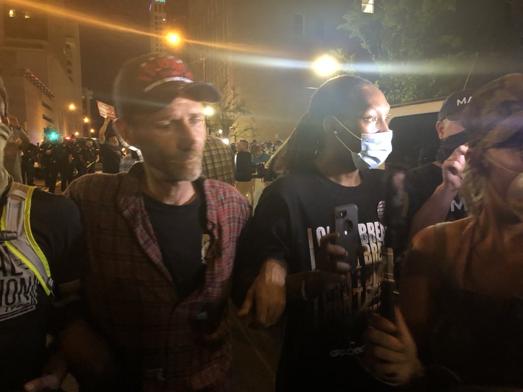 Some kind of chemical irritant used against crowd. Connection sucks, can’t tweet much but filming on cameraHere, Trump supporter and Black Lives Matter guy join in a line to keep crowd and police separated and de-escalate