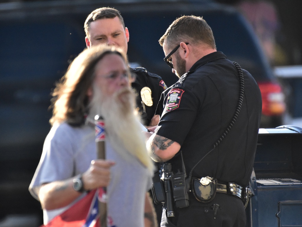 Multiple Confederates were armed and carrying flags in protest. In NC it is illegal for protesters to “willfully or intentionally possess or have immediate access to any dangerous weapons.”