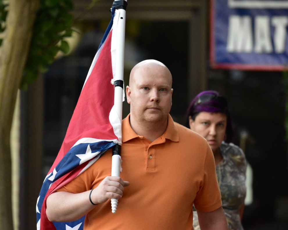 Multiple Confederates were armed and carrying flags in protest. In NC it is illegal for protesters to “willfully or intentionally possess or have immediate access to any dangerous weapons.”