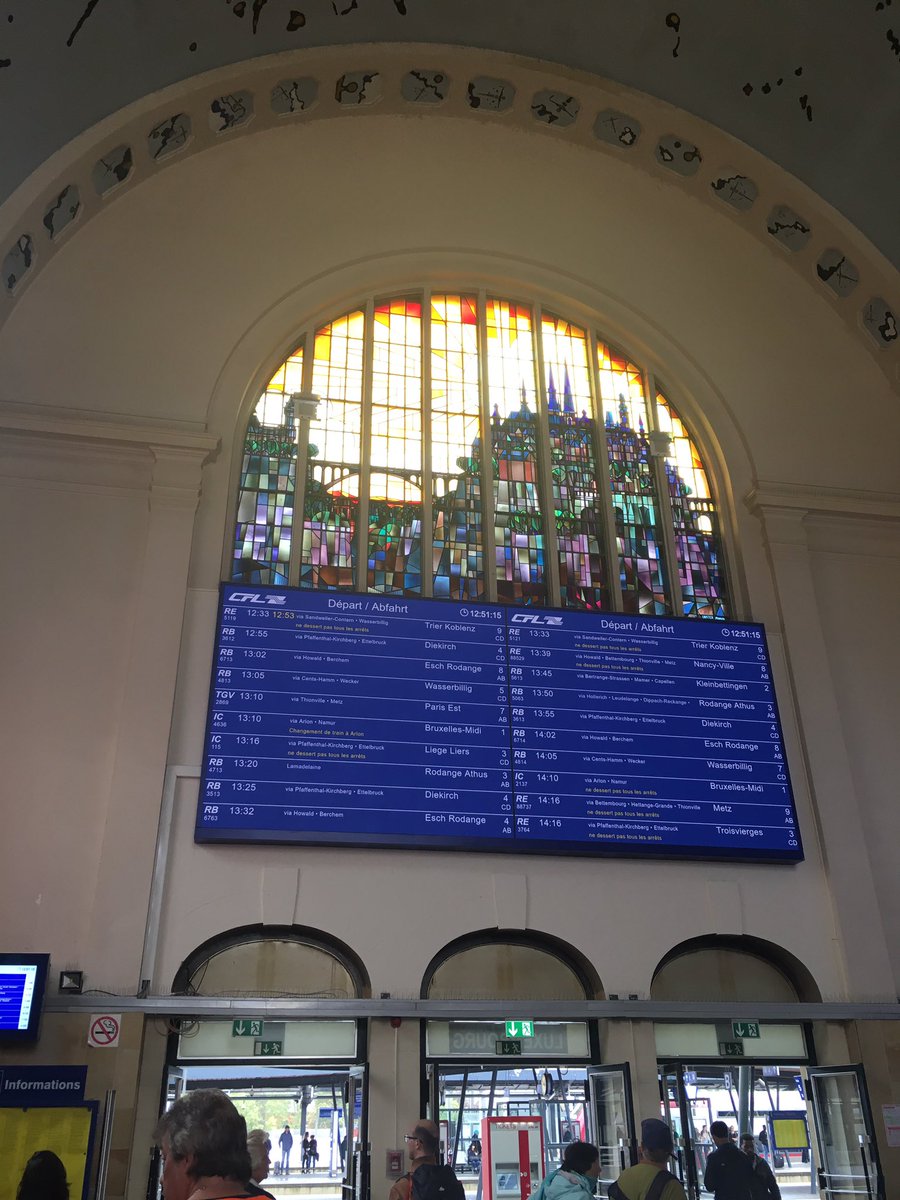 1st view  A lovely stained-glass window in the station, the info board-cum-totem board, bike hire,  buses & an election poster in Luxembourgish if you want to see what this weird language looks like. Basically dodgy Germany with a French twang  #Luxembourg  #Luxembourgish