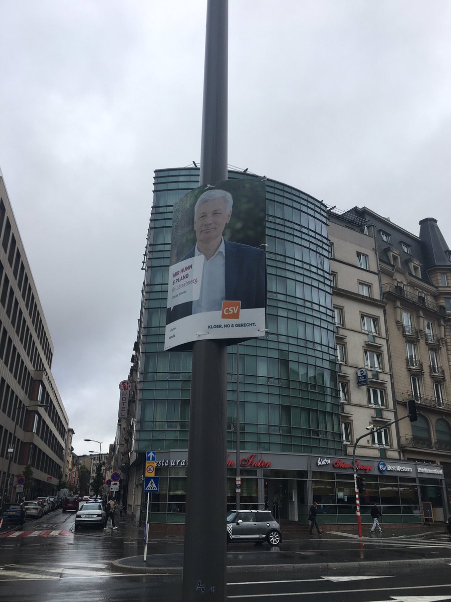 1st view  A lovely stained-glass window in the station, the info board-cum-totem board, bike hire,  buses & an election poster in Luxembourgish if you want to see what this weird language looks like. Basically dodgy Germany with a French twang  #Luxembourg  #Luxembourgish