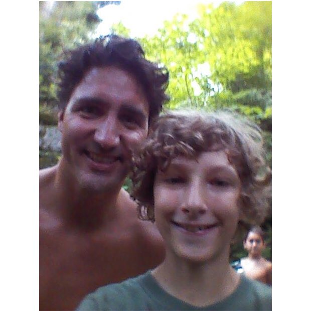 Who is the boy in the background? It’s not Turdeau’s children, nor the family that bumped into him as the boy only has a sister.