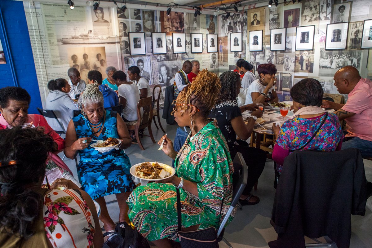 Last year, we welcomed 12 Windrush Generation elders and their families to our museum, where, alongside artist EVEWRIGHT, we ate together and shared stories within  @EvewrightStudio's Caribbean Takeaway Takeover installation. (Image: EVEWRIGHT)  #WindrushDay2020 4/6