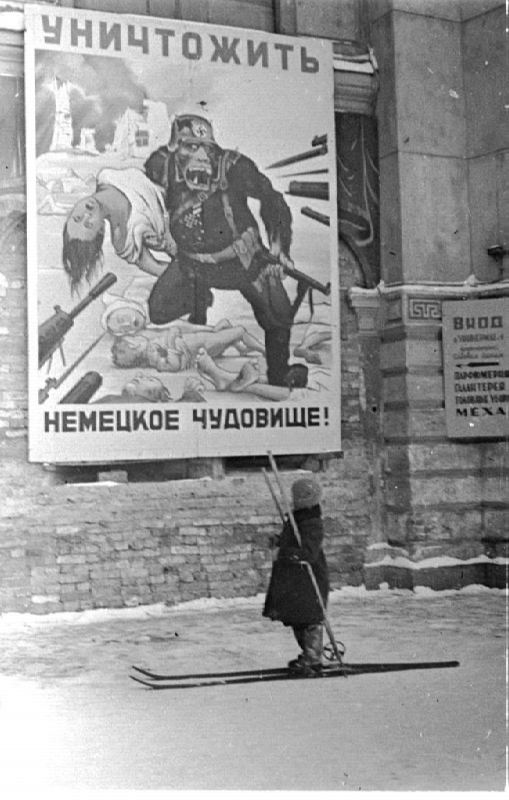 A child on skis looks up at a poster enjoining citizens to "Destroy the German monster!" Another from Leningrad.
