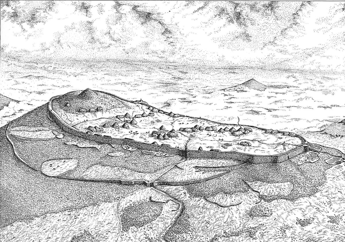 Tre'r Ceiri sits on a steeply-sloping site, its summit occupied by a large early Bronze Age burial cairn - quite clearly preserved, and well-respected by those who later built the wider hillfort.