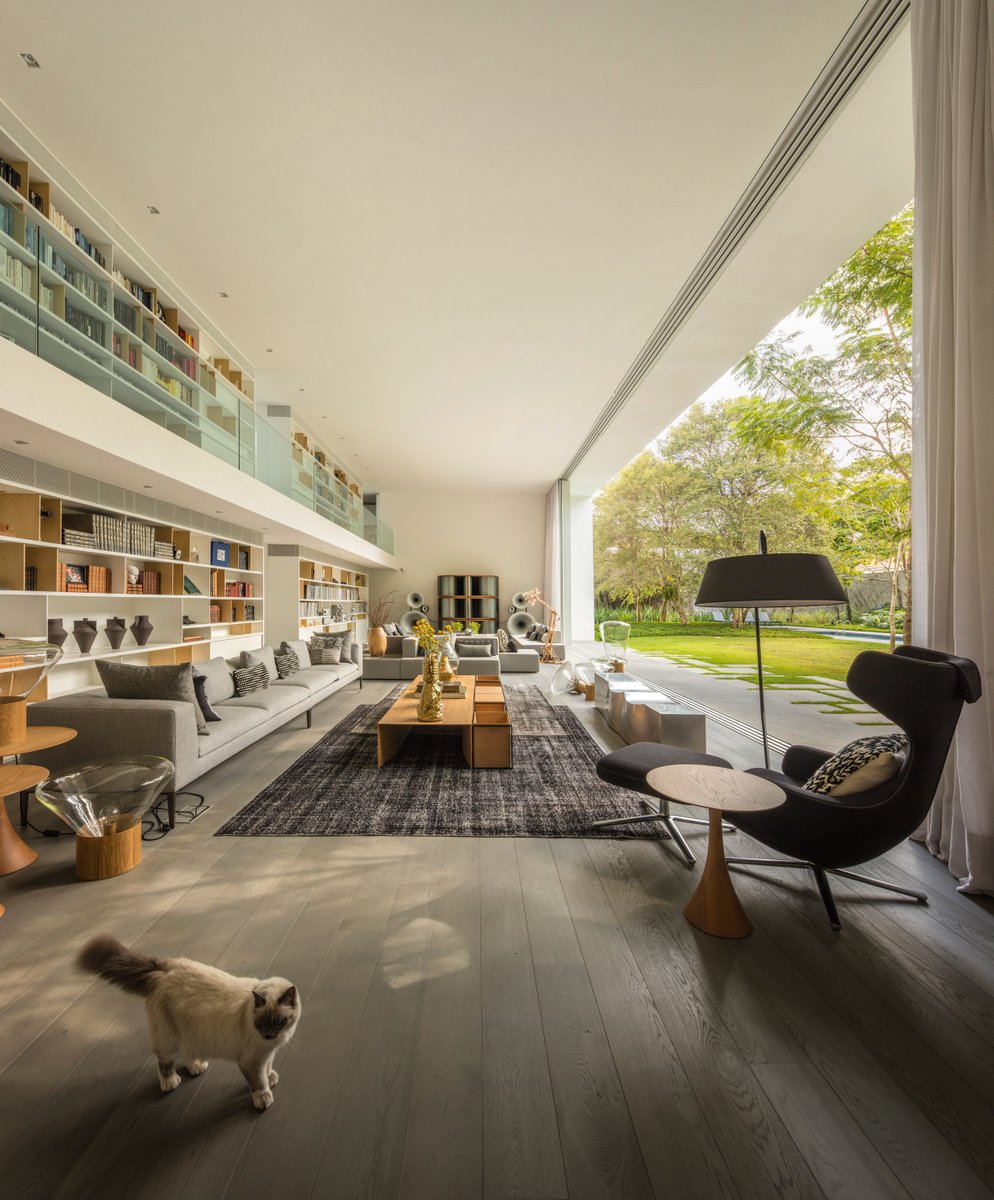Massive double height living room with a mezzanine library opening up to the gardens, São Paulo, Brazil  #interiors #architecture