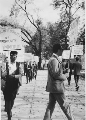 In recognition of  #Pride   month, I want to share & celebrate the story of the trailblazing Black woman in these photos: Ernestine Eckstein.These photos of her picketing w/a sign reading "Denial of Equality of Opportunity is Immoral" were taken in Oct of 1965 in front of the WH.